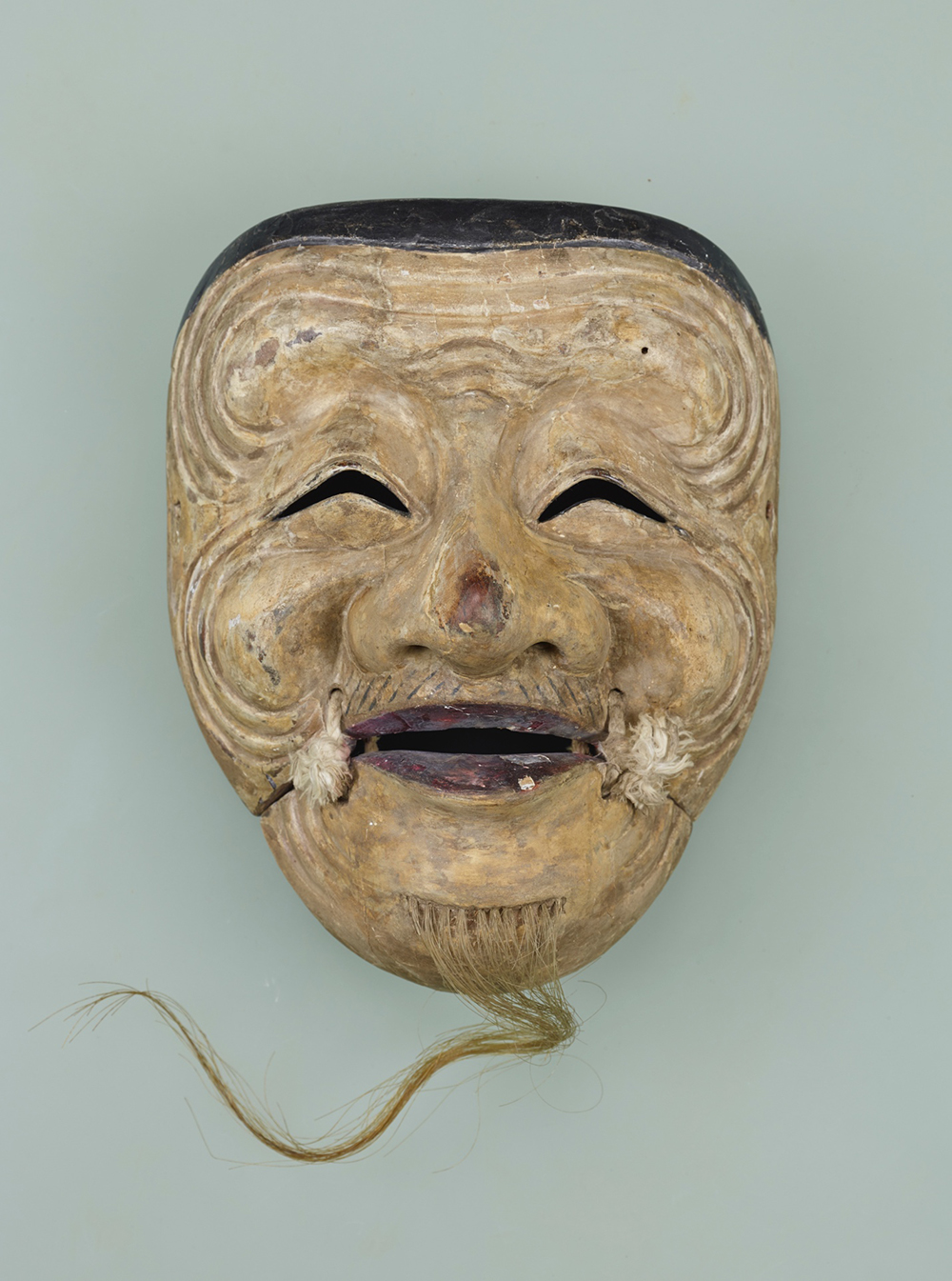 Traditional Noh mask of the cheerful old man, Okina (Hakushiki-jō), used to illustrate parallels with characters in Dodes'ka-den.
