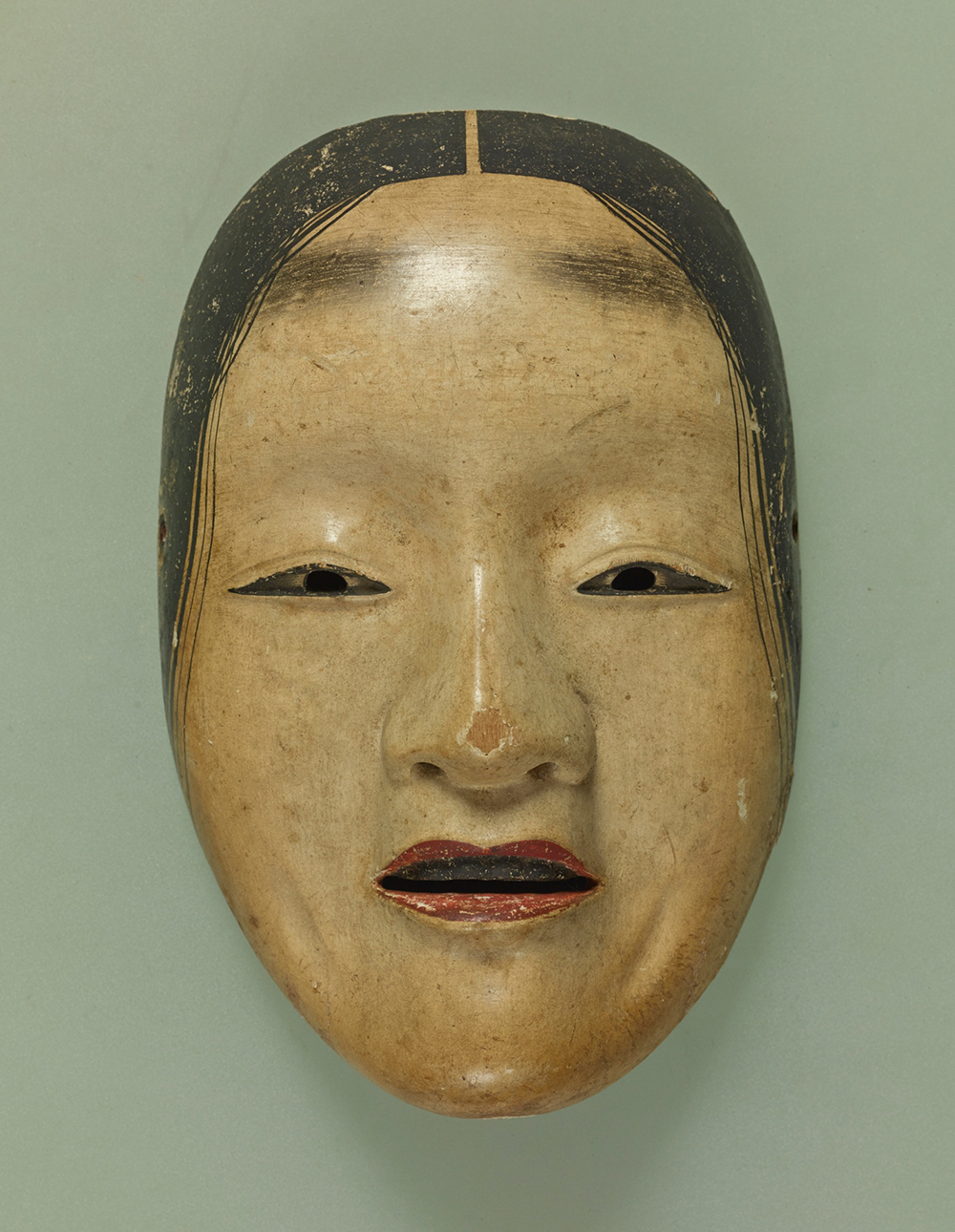 Shakumi-onna Noh mask representing a sorrowful woman, compared to the character Ocho.