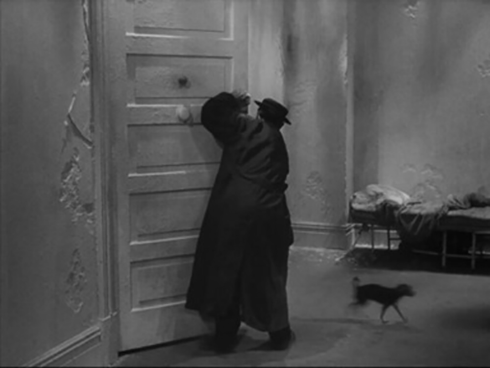 O attempting to expel a cat from the room while a dog re-enters in Samuel Beckett's Film.