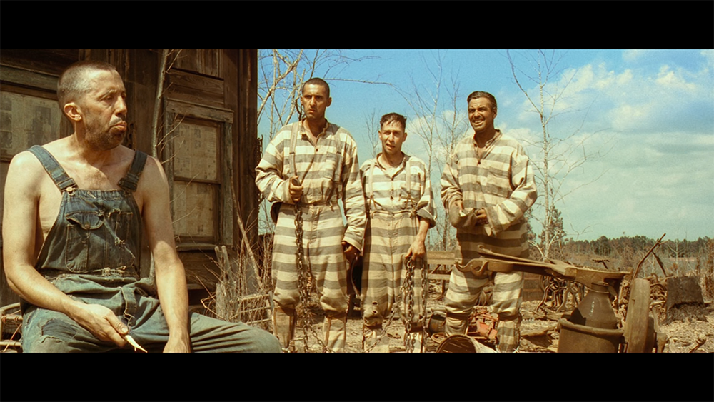 Depression-era Mississippi scene from O Brother, Where Art Thou? showing escaped convicts near a rural shack.