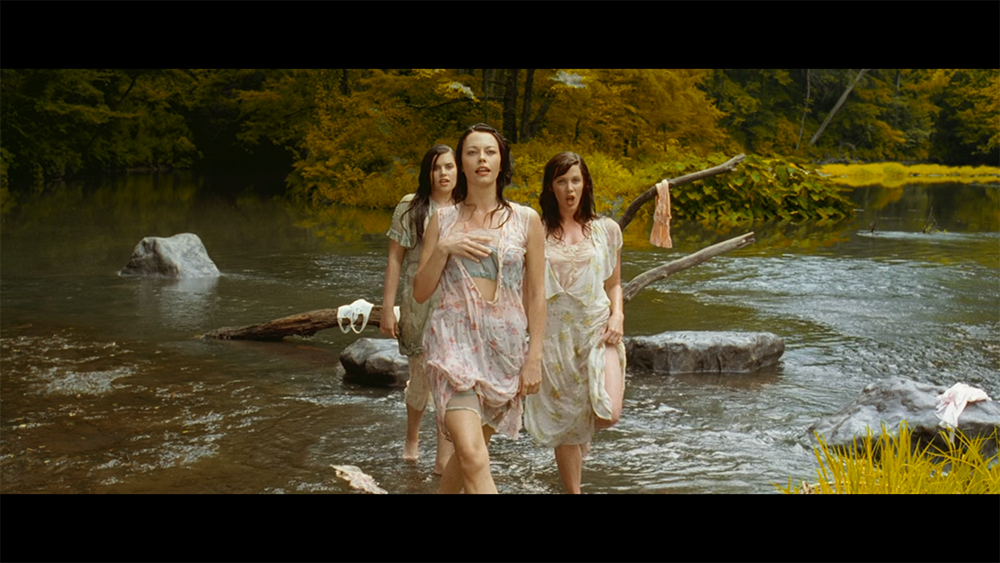 Three sirens standing in a river in O Brother, Where Art Thou?, emphasizing their unsettling allure.