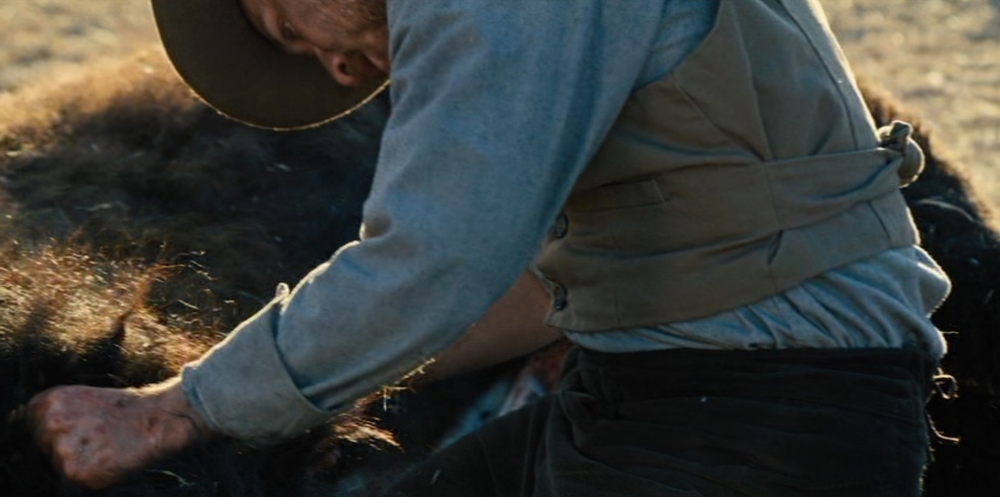 Andrews skins a buffalo, killed by Miller.